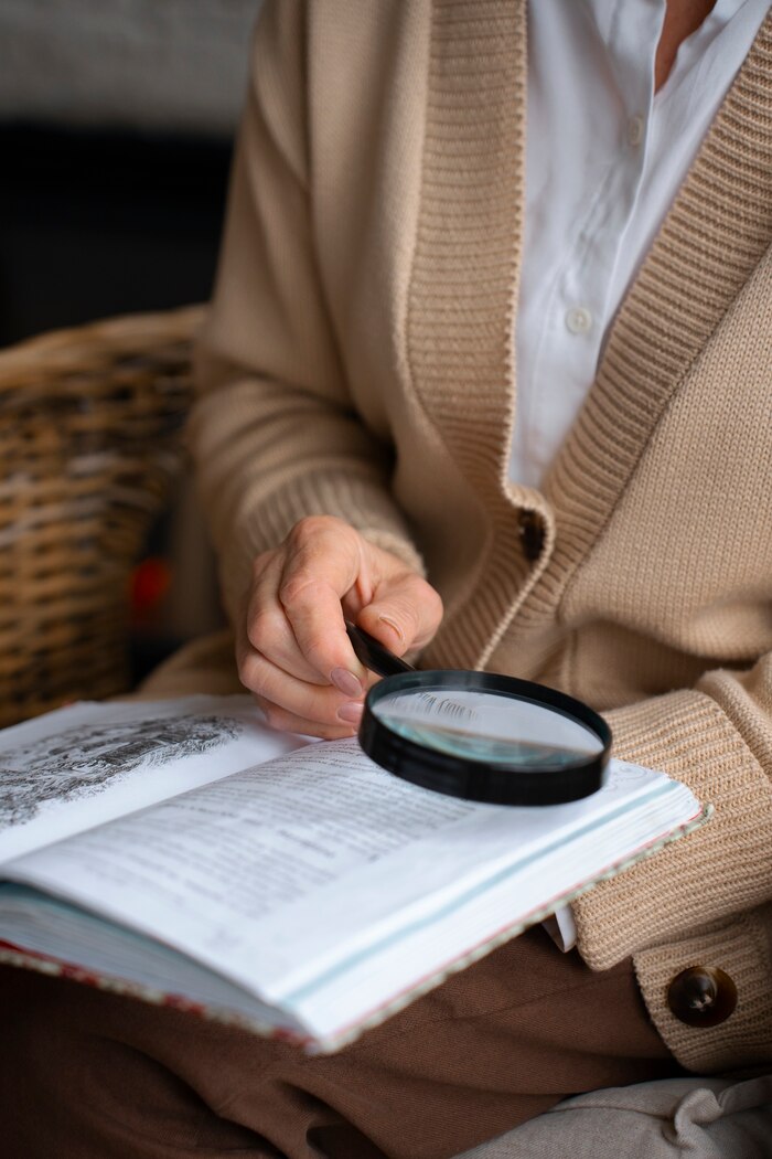 elderly-woman-reading-while-using-magnifying-glass